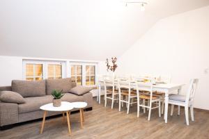 a living room with a couch and a table at Talblickhof in Waldmünchen