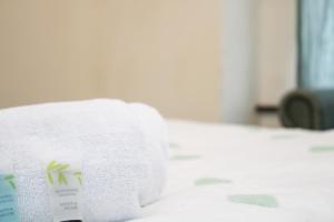 a stack of towels sitting on a bed at Centrally located double rooms in Southampton