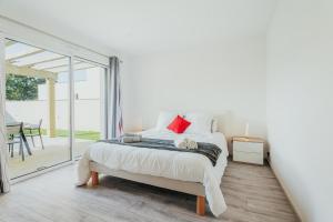 a bedroom with a bed and a sliding glass door at Maison avec jardin proche Dinan in Trévron