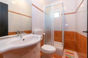 a bathroom with a sink and a toilet and a shower at Apartment Per in Stara Novalja