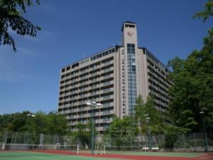 a large building with a clock tower on top of it at Villa Kitakaruizawa L-Wing in Tsumagoi
