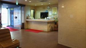 a lobby with a sink and a counter in a building at HotelYama in Yamanouchi
