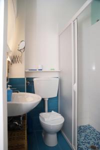 a bathroom with a white toilet and a sink at Kaary Bella Vista in Marina di Ragusa +21 photos