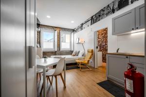 a kitchen and dining room with a table and chairs at SÃO VICTOR Studios HISTORIC CENTER in Braga