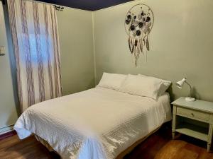 a bedroom with a bed and a clock on the wall at Hayduke's Hideout in Moab