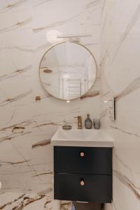 a bathroom with a sink and a mirror at Dziewięćsił &Chaber _domki blisko lasu in Grywałd +36 photos