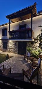 a patio with benches in front of a building at Villa Prespa - villa rental in Dolno Dupeni +2 photos