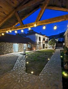 an outdoor patio with lights and a building at Villa Prespa - villa rental in Dolno Dupeni