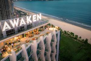 an aerial view of a building next to a beach at Awaken Da Nang Hotel in Danang