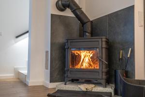 a stove with a fire in a room at Nydala Eco in Rzepiska