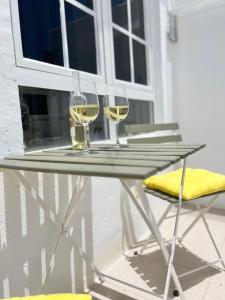 two glasses of white wine sitting on a table at Imperial Villas I Mar y Playa in Puerto del Carmen