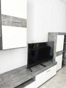 a flat screen tv sitting on a white entertainment center at Imperial Villas I Mar y Playa in Puerto del Carmen