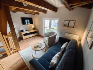 a living room with a blue couch and a table at Trafohaus in Zingst
