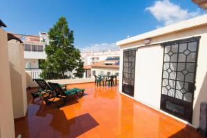 a balcony with chairs and tables on a building at Hostel Monaco in Funchal