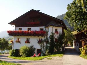 a white house with flowers on the side of it at Pardellerhof Lüsen in Luson