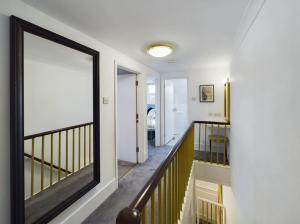 a hallway with a large window in a house at Central Eastbourne Escape with Rooftop Jacuzzi in Eastbourne