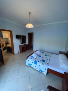 a bedroom with a bed and a tv in it at Studios&apartments Thomas in Vasiliki