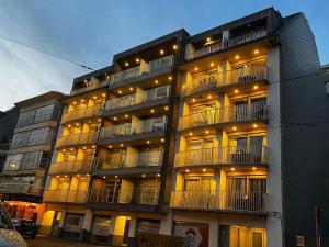 a large apartment building with lights on it at DePanne FiftyOne in De Panne