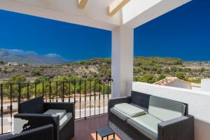 a balcony with chairs and a view of the mountains at CostaBlancaDreams Casa Tinick in Calpe in Empedrola