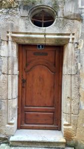 a large wooden door in a stone building at Chez MU & CRIS in Mende