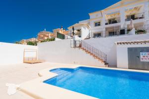 a villa with a swimming pool in front of a building at CostaBlancaDreams Casa Tinick in Calpe in Empedrola