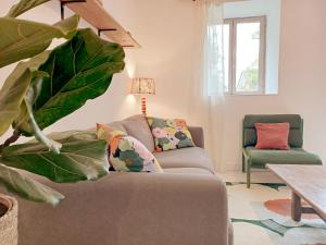 a living room with a couch and a chair at La Garencière - Les 3 pommes in Champfleur