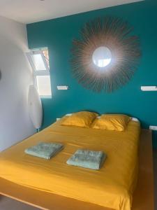 a bedroom with a large yellow bed with a blue wall at Casa Branca in Ponta do Sol