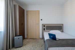 Postel nebo postele na pokoji v ubytování Antares Hotel