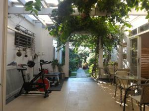 an outdoor patio with a bike and a table and chairs at Sunshine Bungalow in Phú Quốc