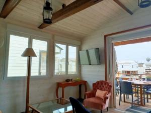 a living room with a glass table and chairs at CHALET la Perle de Gruissan in Gruissan +21 photos