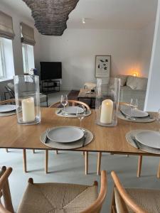 a table with plates and candles on top of it at Schumis Ferienhus in Garding
