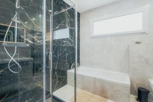 a shower with a glass door in a bathroom at Maison avec jardin proche Dinan in Trévron +22 photos