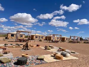 a group of tents in the middle of a desert at Rimal tata camp in Migourdâne