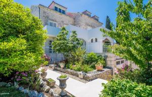 an exterior view of a house with plants and trees at Cozy Apartment In Zaton Veliki in Zaton