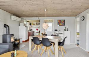a kitchen and dining room with a table and chairs at Gorgeous Home In Broager With Wifi in Broager