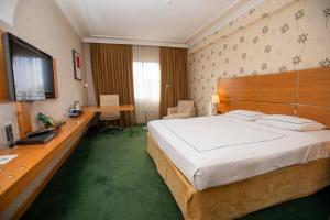 A bed or beds in a room at Anemon Grand Manisa Otel