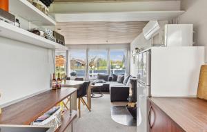 a kitchen and living room with a couch and a table at Gorgeous Home In Broager With Wifi in Broager