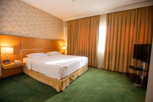 A bed or beds in a room at Anemon Grand Manisa Otel
