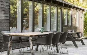 a wooden table and chairs on a patio at 3 Bedroom Stunning Home In Skjern in Skjern