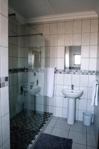 a bathroom with a shower and a sink at Die C Skulp in Hartenbos +22 photos