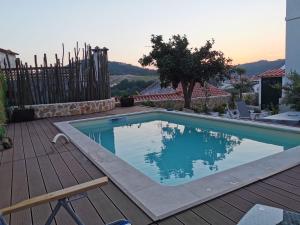 a swimming pool on a deck next to a house at Casa de Penela in Penela