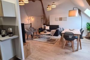 a living room with a couch and a table at L'Olympe - EasyEscale in Romilly-sur-Seine