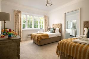 ein Schlafzimmer mit zwei Betten und einem Fenster in der Unterkunft Gresham Hall - Norfolk Cottage Agency in Norwich