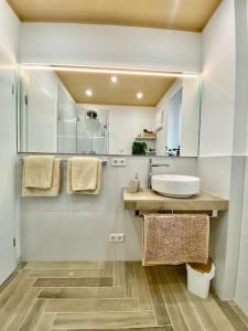 a white bathroom with a sink and a mirror at Komfort - Suite zentral, mit Balkon und Waschmaschine in Düsseldorf +24 photos