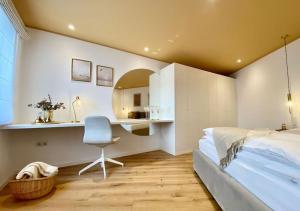 a bedroom with a bed and a chair and a mirror at Komfort - Suite zentral, mit Balkon und Waschmaschine in Düsseldorf