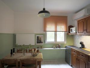 a kitchen with a table and a sink and a tub at Garden House Retreat in Drama