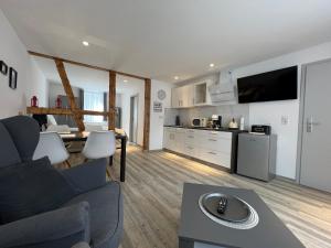 a kitchen and living room with a couch and a table at Charming Retreats Hasselfelde in Hasselfelde