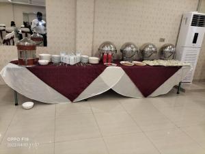a table with food on it in a room at HOTEL DAY IN Empouriem in Lahore
