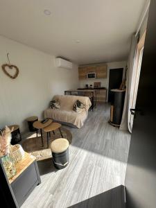 a living room with a bed and a table at Chalet moderne animaux acceptés in Vittel