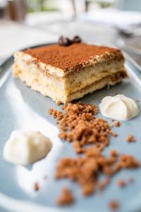 a piece of cake sitting on top of a plate at Hotel la Palma au Lac in Locarno